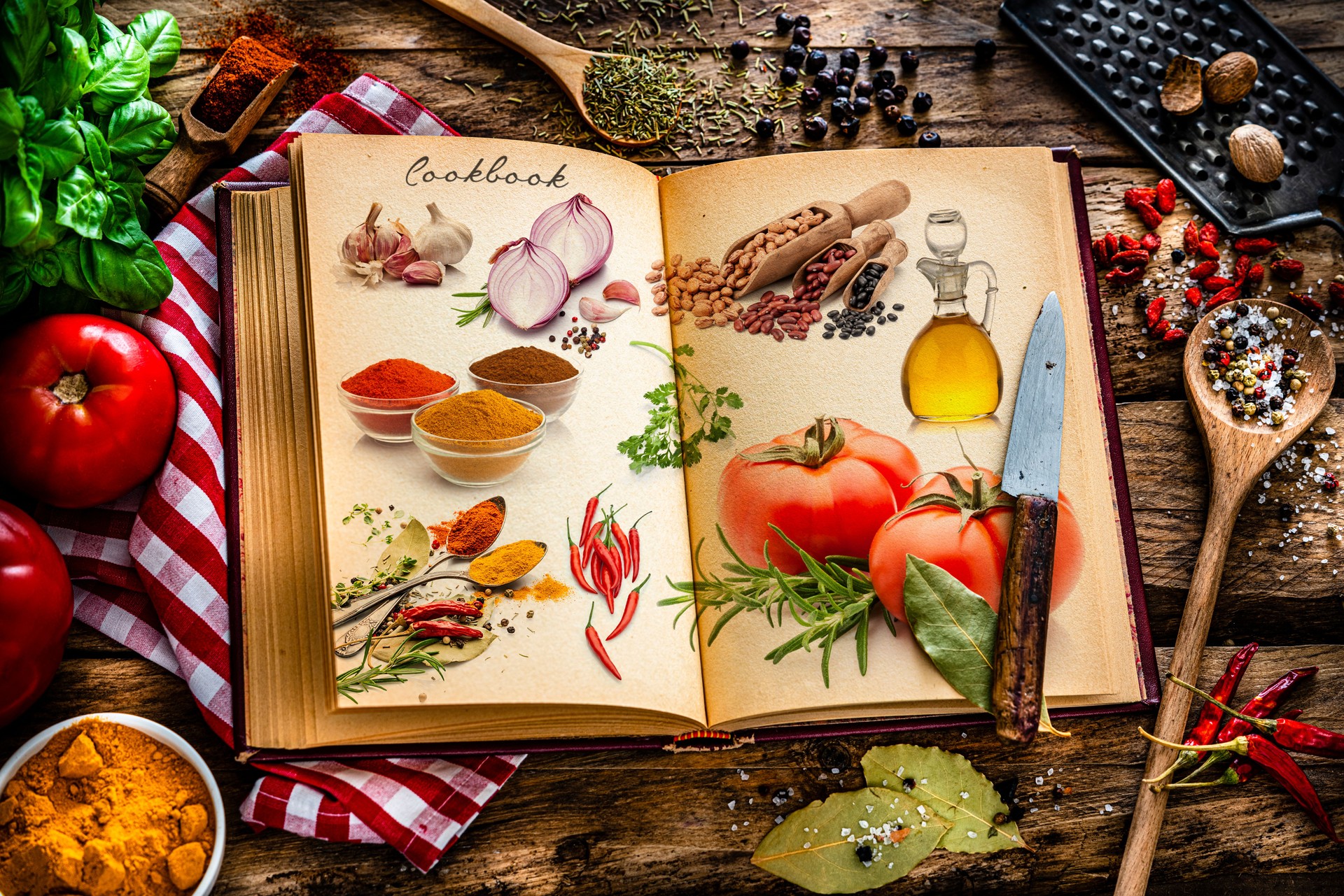 Cookbook with ingredients on rustic kitchen table